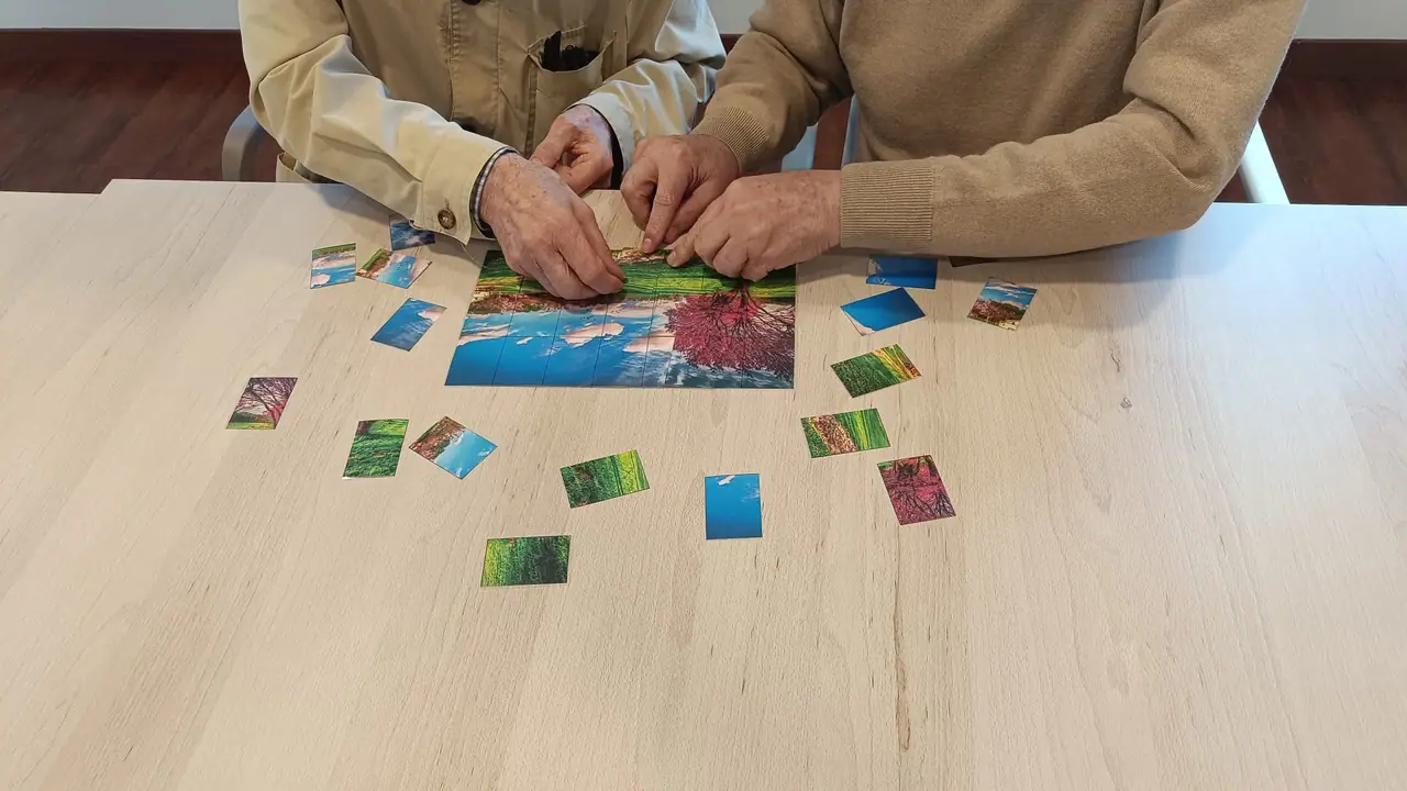 Residentes de Mejora Avilés jugando a un juego de memoria con tarjetas de colores